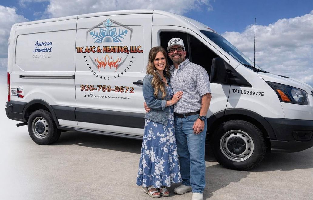Couple posing beside a white service van with a company logo on the side.